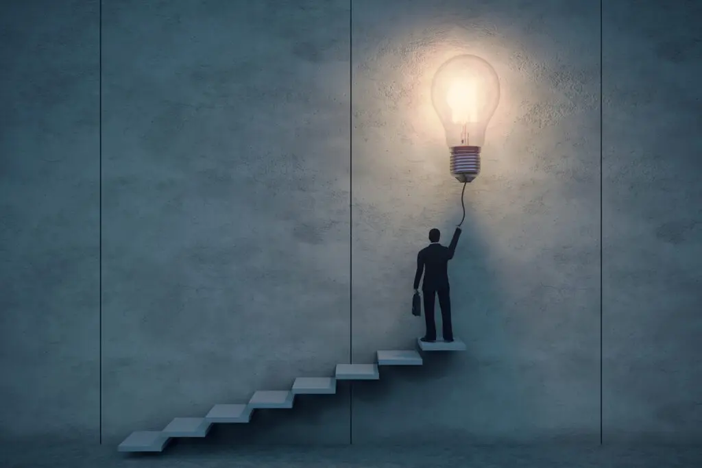 A figure climbs stairs to pull a cord lighting a bulb.