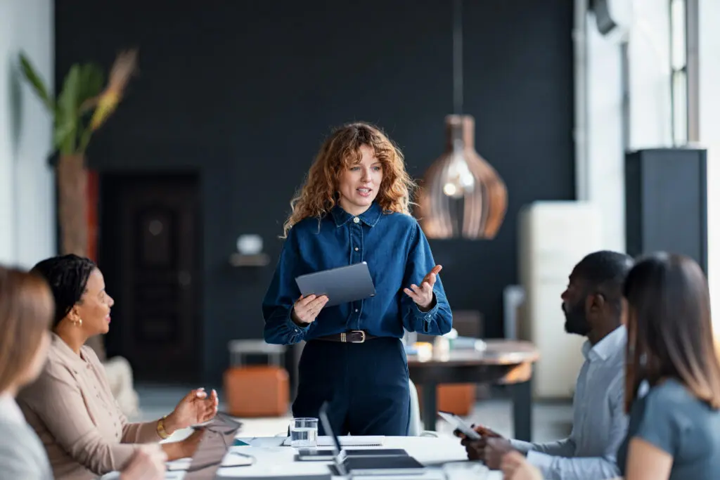 A woman presenting ideas to colleagues in a modern office.