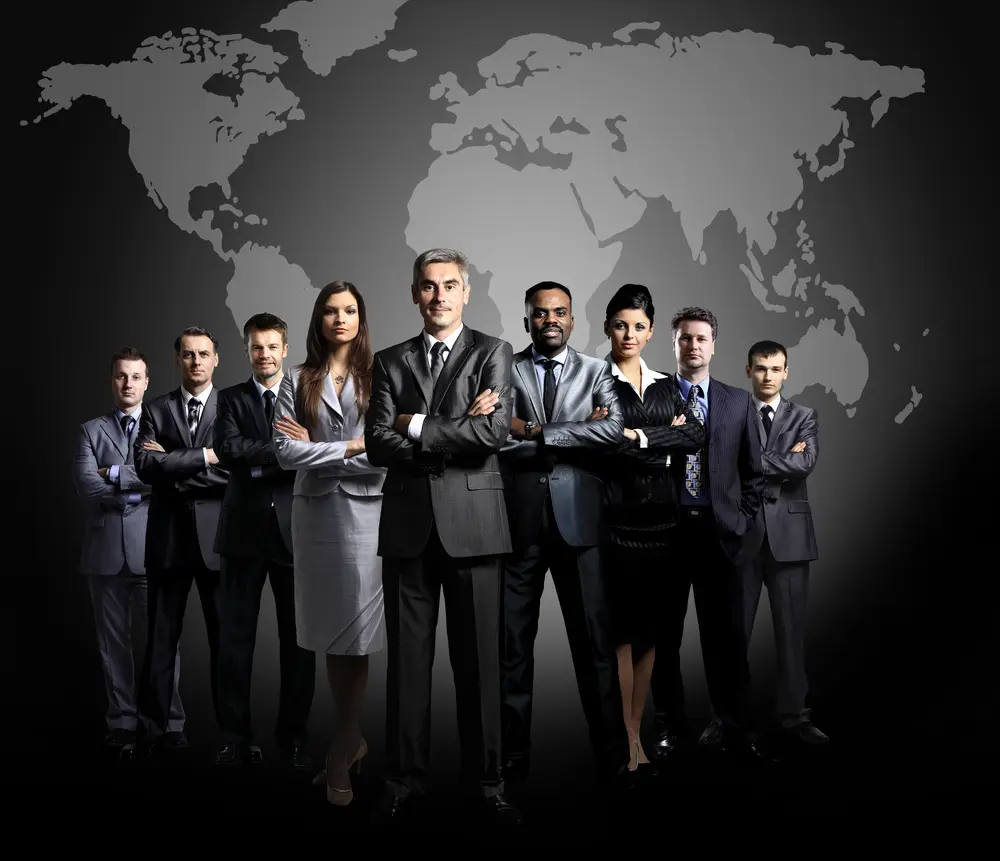 Confident business team standing together with arms crossed against world map background.
