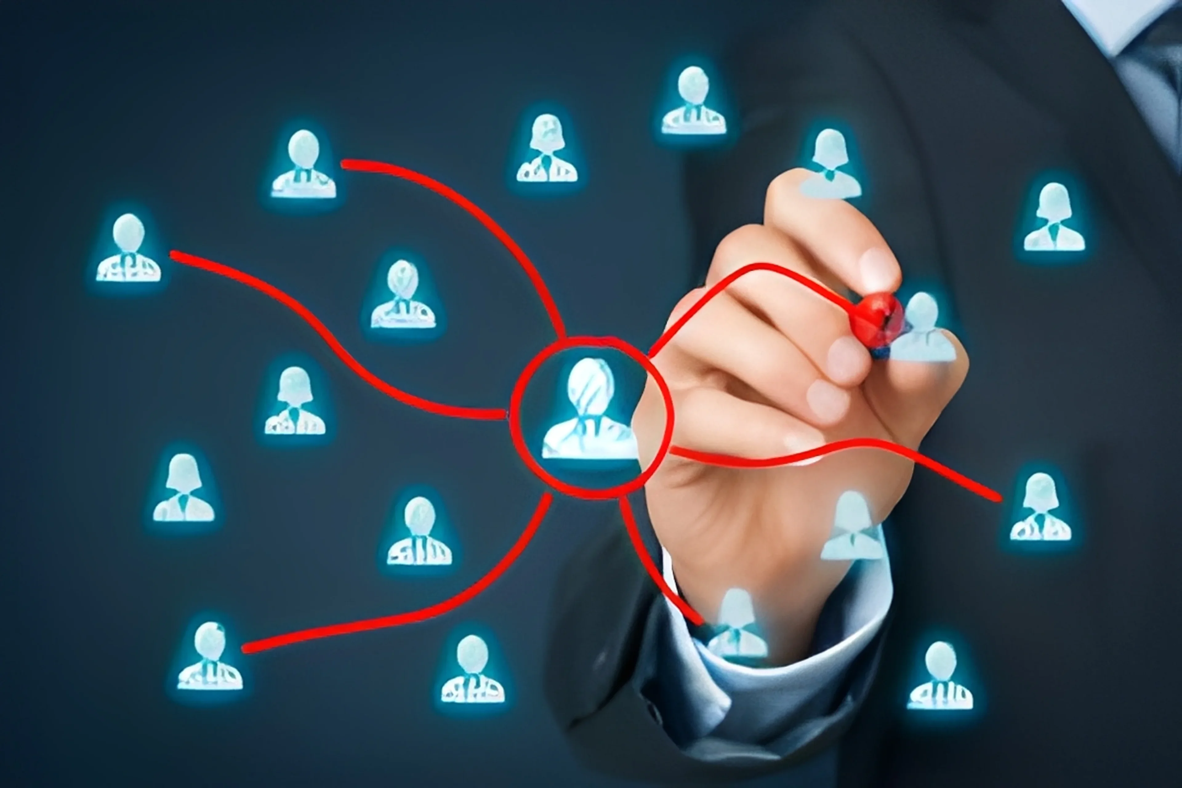 Hand drawing a network of connected user icons symbolizing communication.