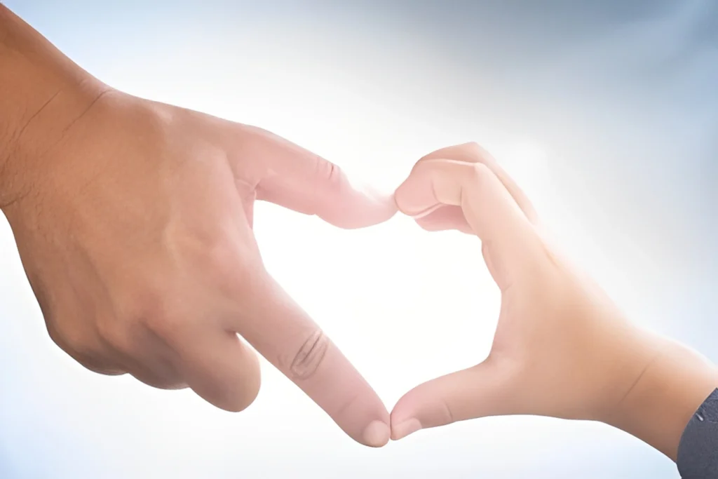 Two hands forming a heart shape symbolizing love and unity.