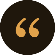Orange quotation marks on a black circle.